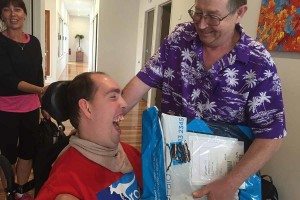 Nick receiving his new communication device at the Wooloowin Share House