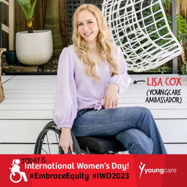 Lisa Cox is smiling in an outdoor setting with white floorboards and green plants. They have blonde hair and are smiling warmly. Lisa is sitting in a manual wheelchair and is wearing a purple blouse and dark blue jeans. Words are positioned beside them with an arrow pointing in their direction reading "Lisa Cox (Youngcare Ambassador)". A banner under the image reads "Today is International Women's Day! #EmbraceEquity #IWD2023". There is a white Youngcare logo beside this text. 